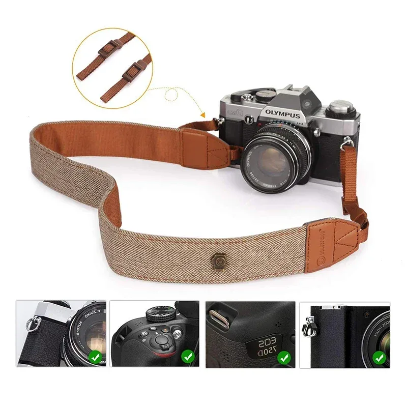 Herringbone cotton camera strap with tan leather tabs laid beside a silver and black film camera