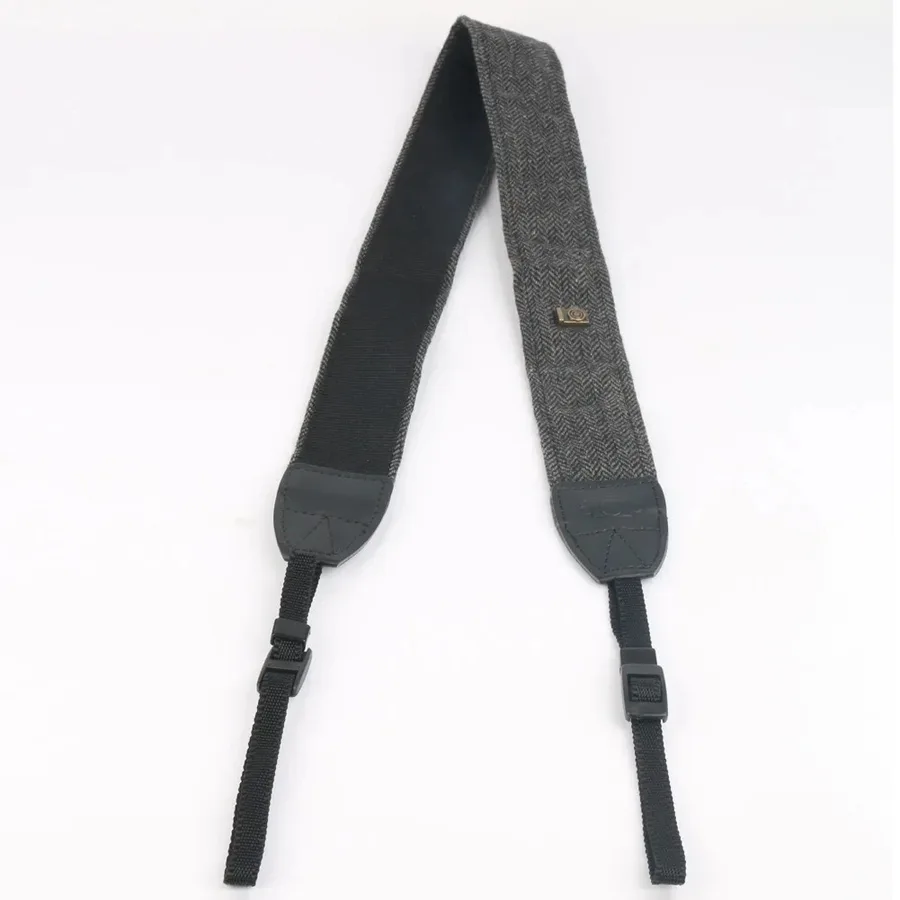 Charcoal cotton camera strap with dark herringbone weave and black leather end tabs